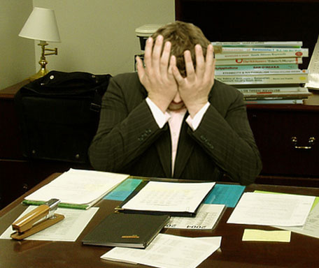 Frustrated_man_at_a_desk_ Frustrated man at a desk