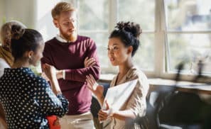 group of people talking in an office setting