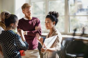 group of people talking in an office setting