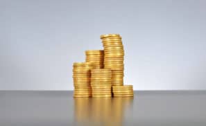gold coins stacked up in several piles