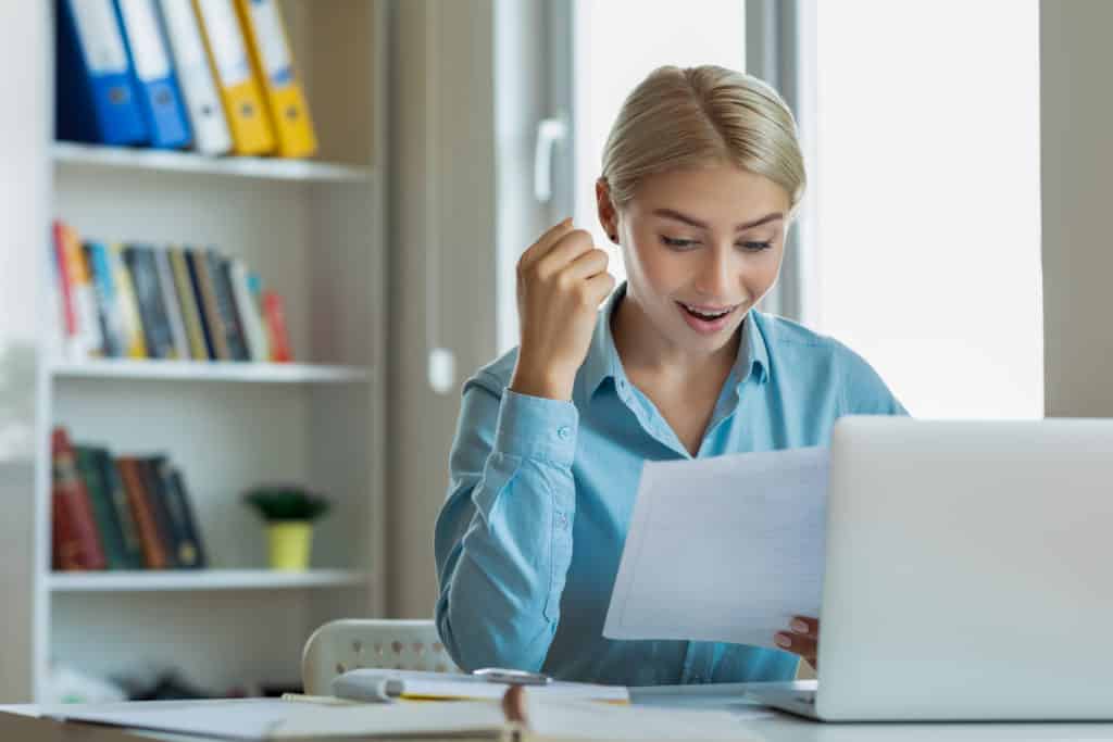 Excited woman reading mail letter with great news